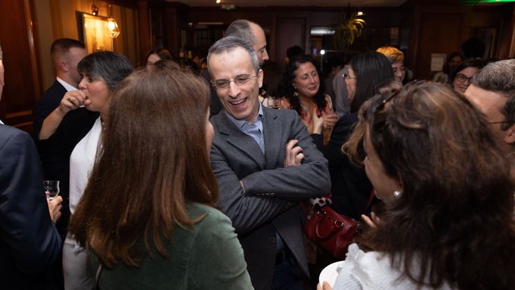 A group of people engaging in a conversation at a social gathering.