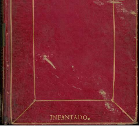 Un libro de cubierta roja con detalles dorados en los bordes.