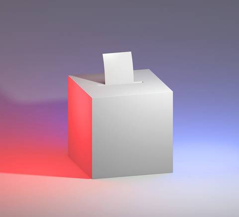 Una urna electoral blanca con una boleta en su interior sobre un fondo de luces de colores.