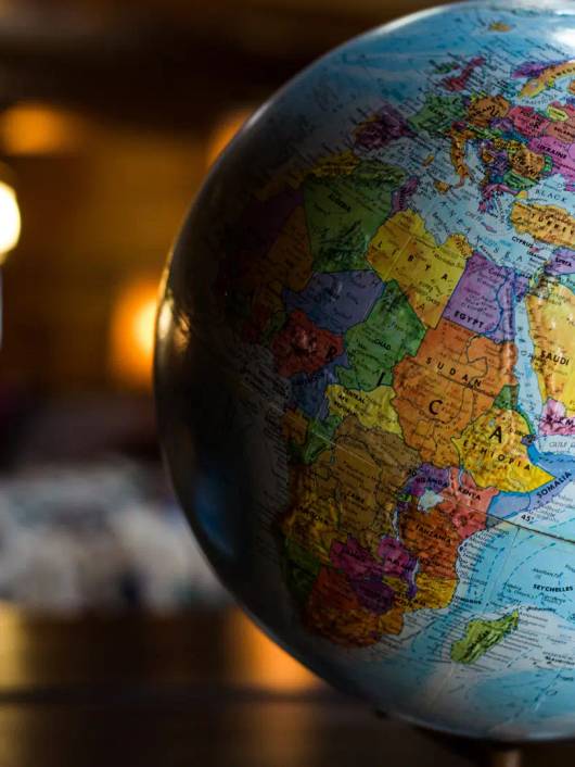Un globo terráqueo con los continentes y océanos representados en colores vibrantes.