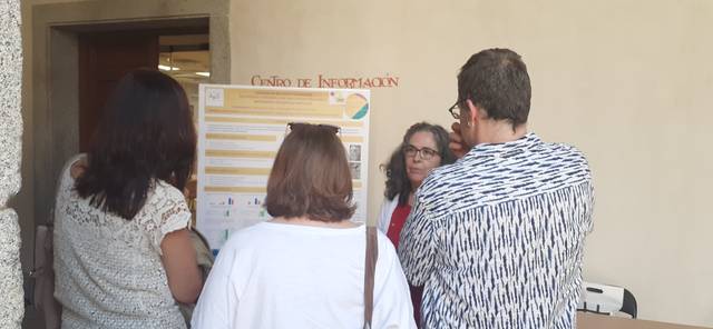 A group of people examining an information board inside a building.