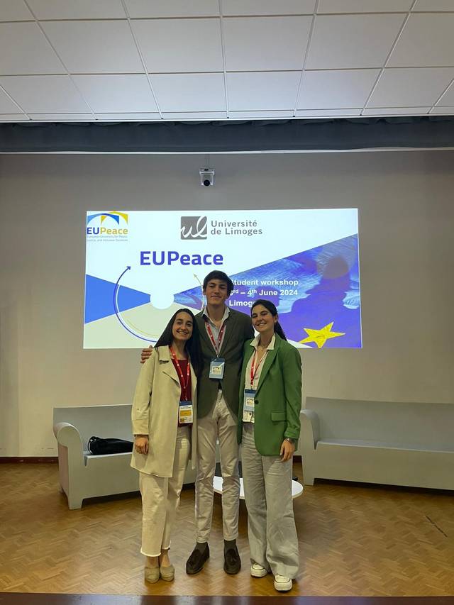 Three individuals standing in front of a presentation screen at a student workshop with the EUPEace and Université de Limoges logos displayed behind them.