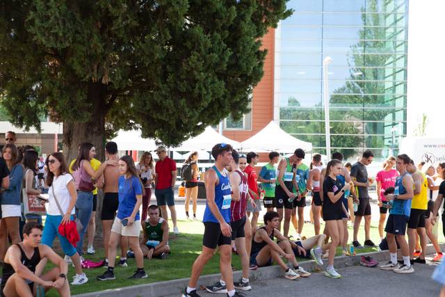 Un grupo de jóvenes atletas se reúne en un evento deportivo al aire libre.
