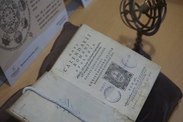 Un antiguo libro de calendario astronómico colocado sobre una superficie elegante.