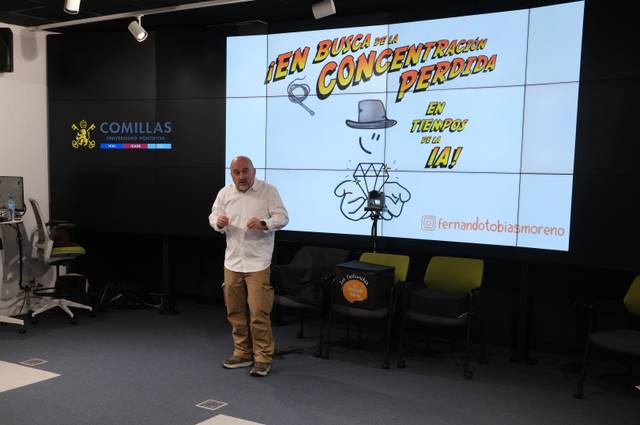 Un hombre presenta una charla sobre la concentración y la inteligencia artificial en un auditorio.