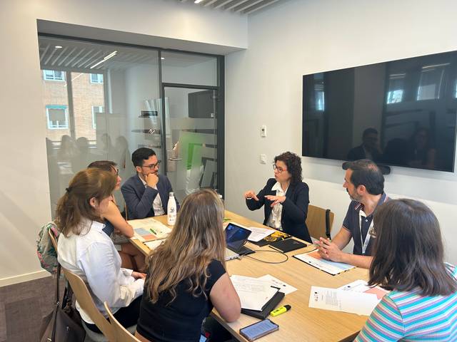 Un grupo de personas está participando en una reunión en una sala de conferencias.