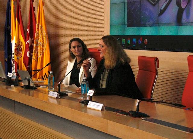 Two women participating in a panel discussion at a conference