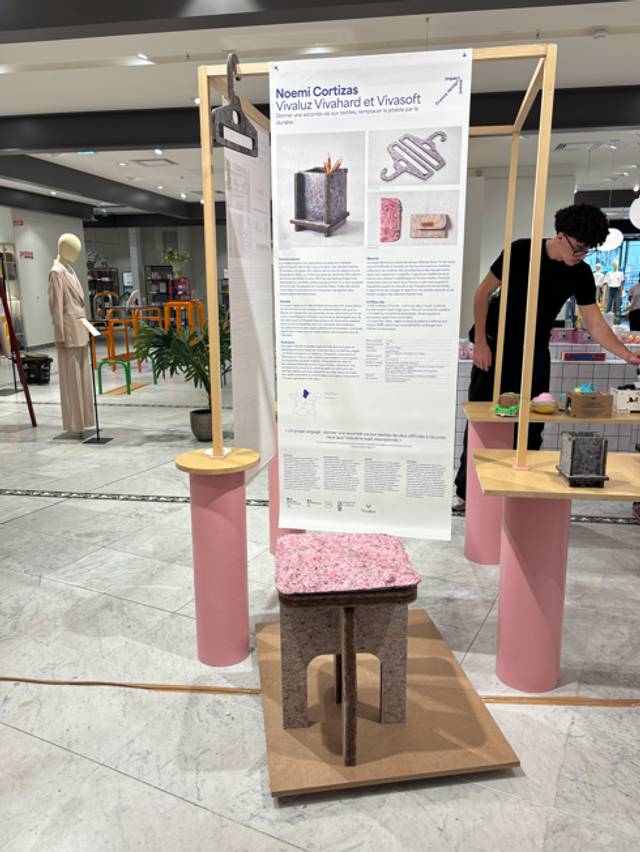 Exposición de un diseño innovador en un espacio comercial con una estructura de soporte de madera y elementos decorativos en tonos pastel.