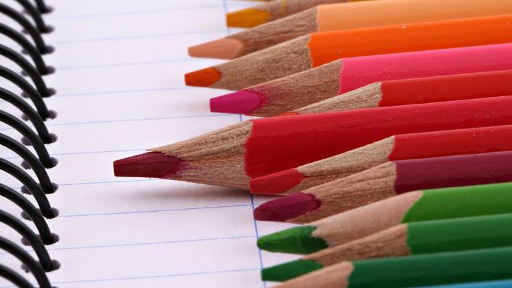 lapices de colores sobre un cuaderno