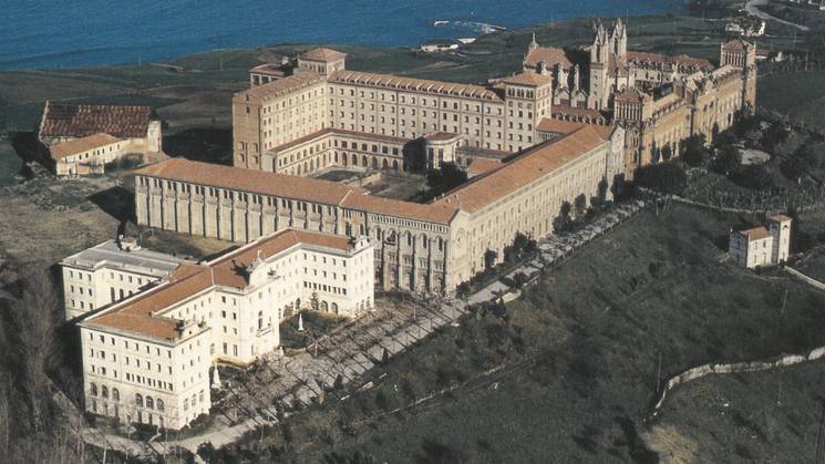 Aerial view of a large historical building complex near the coast.