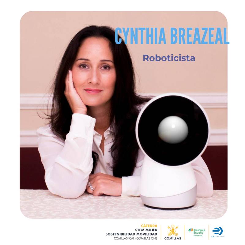La imagen muestra a Cynthia Breazeal, una reconocida roboticista, posando junto a un robot en un ambiente elegante.
