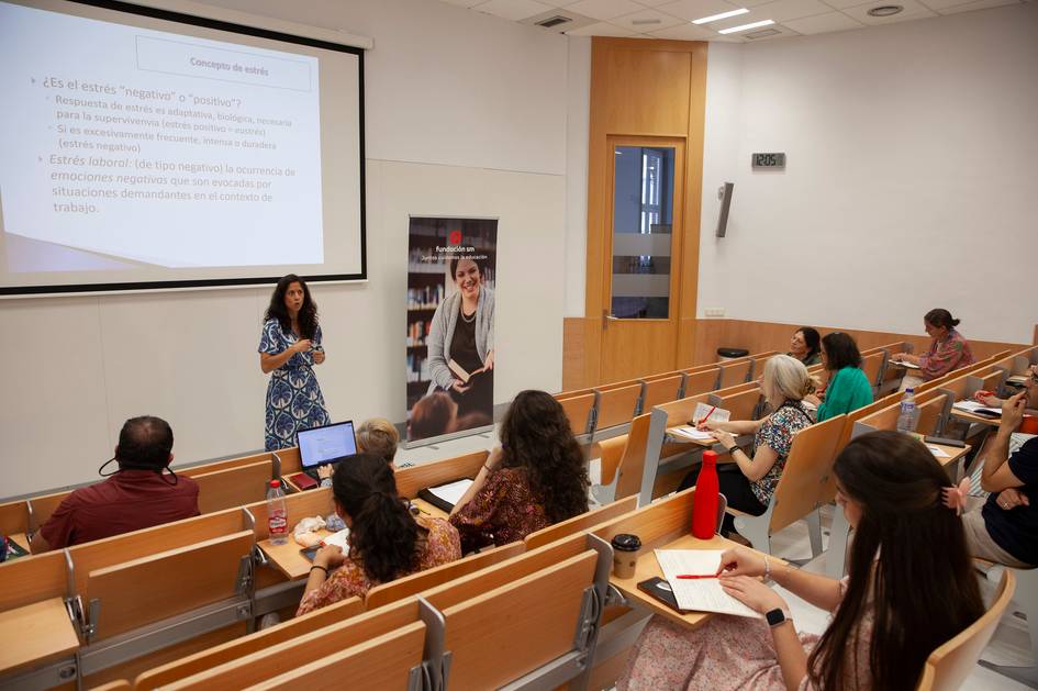 A presentation being given in a well-lit classroom with attentive participants.