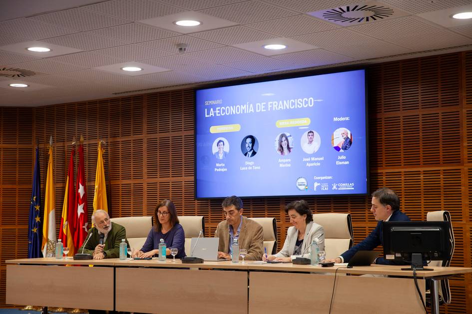 Cinco personas sentadas en un panel durante un evento, con una pantalla mostrando el título 'La Economía de Francisco' y las imágenes de los panelistas.