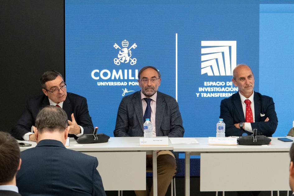 Una mesa redonda con tres ponentes discutiendo en un evento académico.