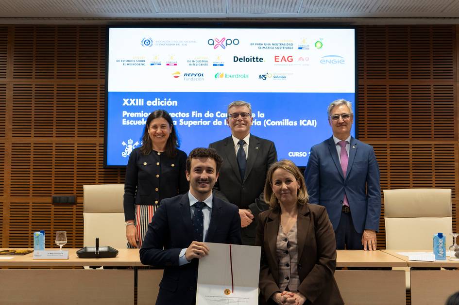 La imagen muestra a un grupo de personas posando en un evento de entrega de premios en una institución educativa.