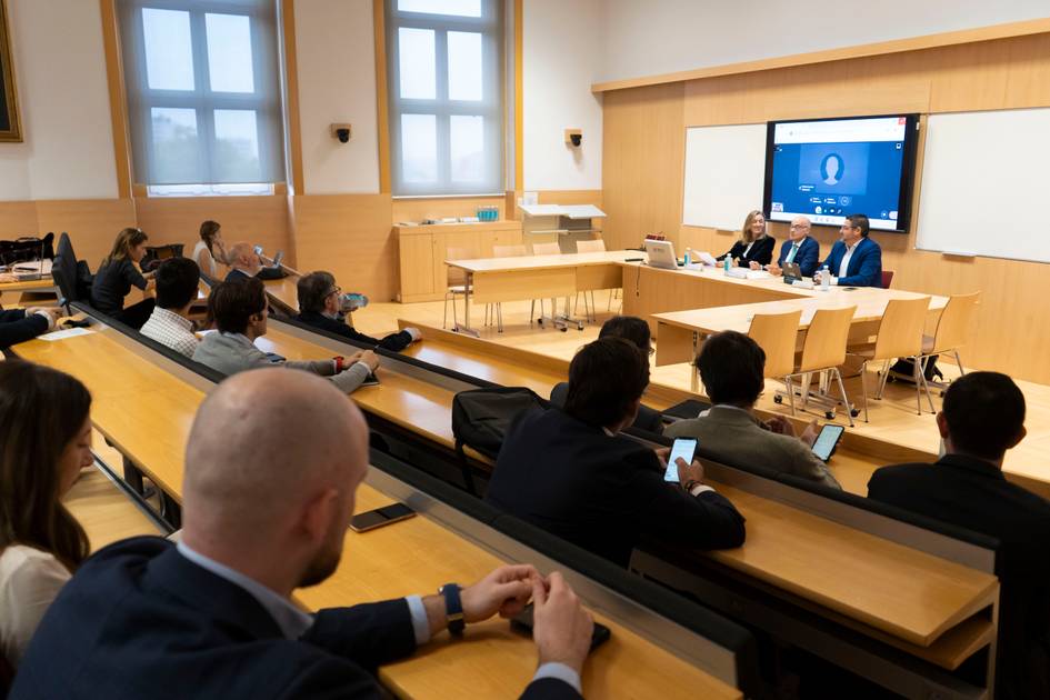 A group of business professionals attending a conference in a modern meeting room.