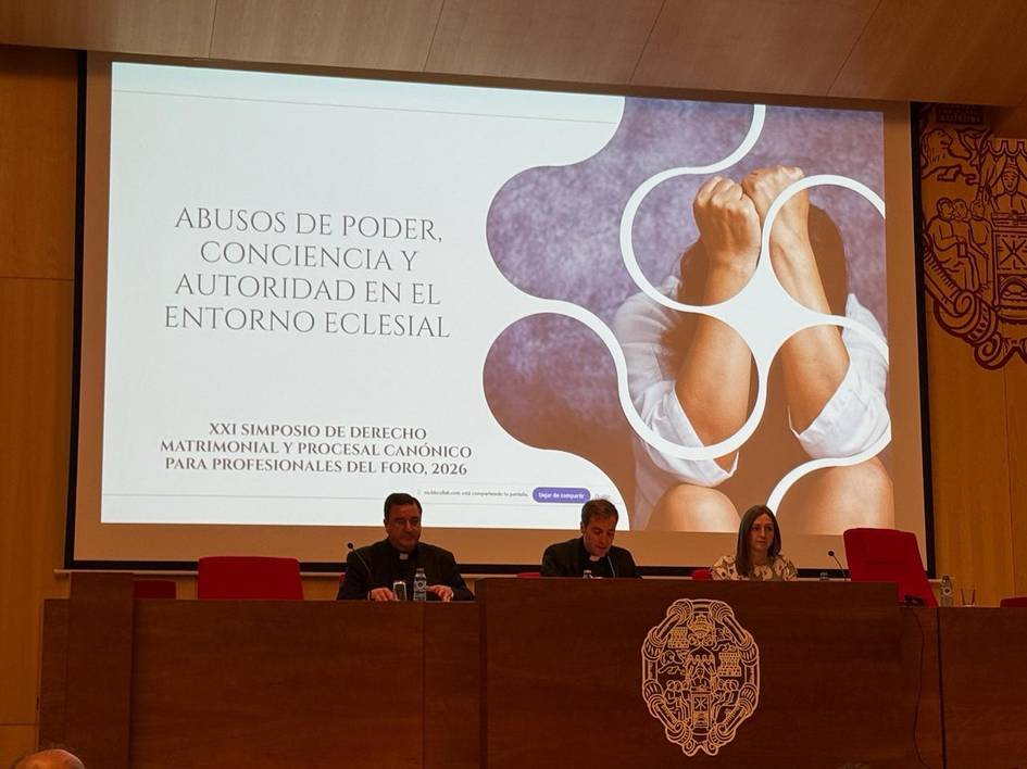 Imagen de un simposio sobre derechos en el entorno eclesial con tres ponentes en un estrado.
