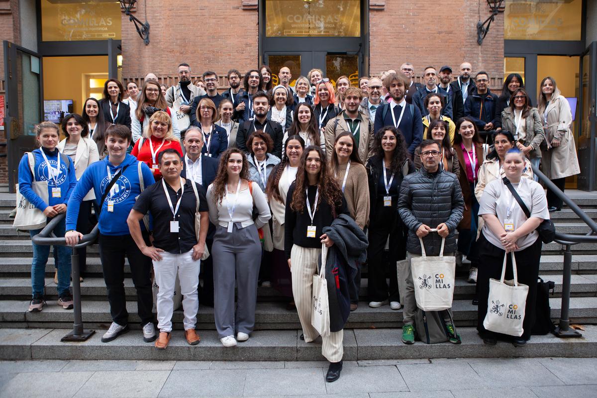 Una multitud de personas posando en grupo en una escalinata de un edificio.