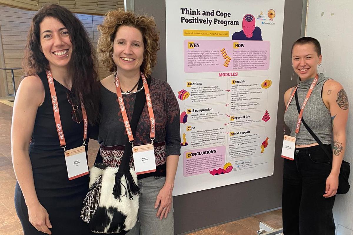 Three women presenting a scientific poster at a conference.