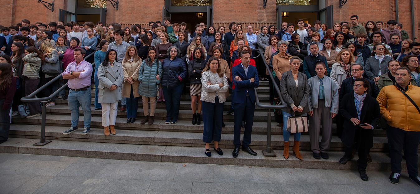 A large group of people gathered outside a building, possibly waiting for an event or announcement.