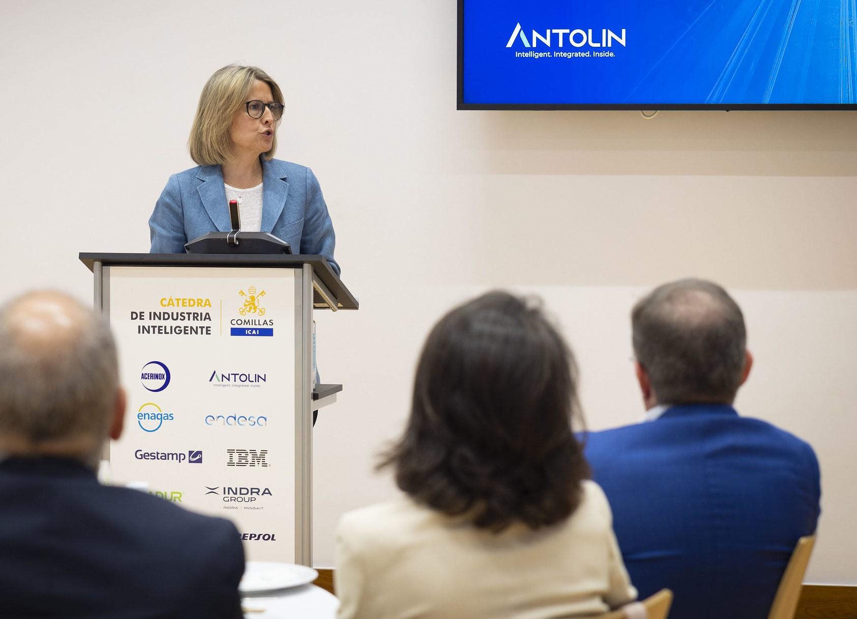 Una mujer presenta un discurso en un evento sobre industria inteligente.
