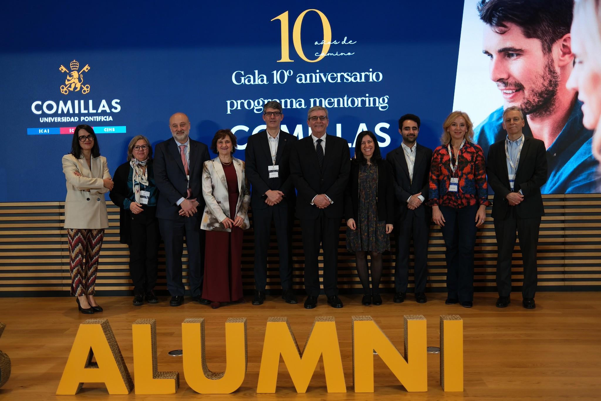 Un grupo de personas posando en una gala del 10º aniversario del programa de mentoring de la Universidad Pontificia Comillas.