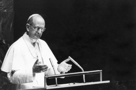 A man in religious attire is giving a speech at a podium.