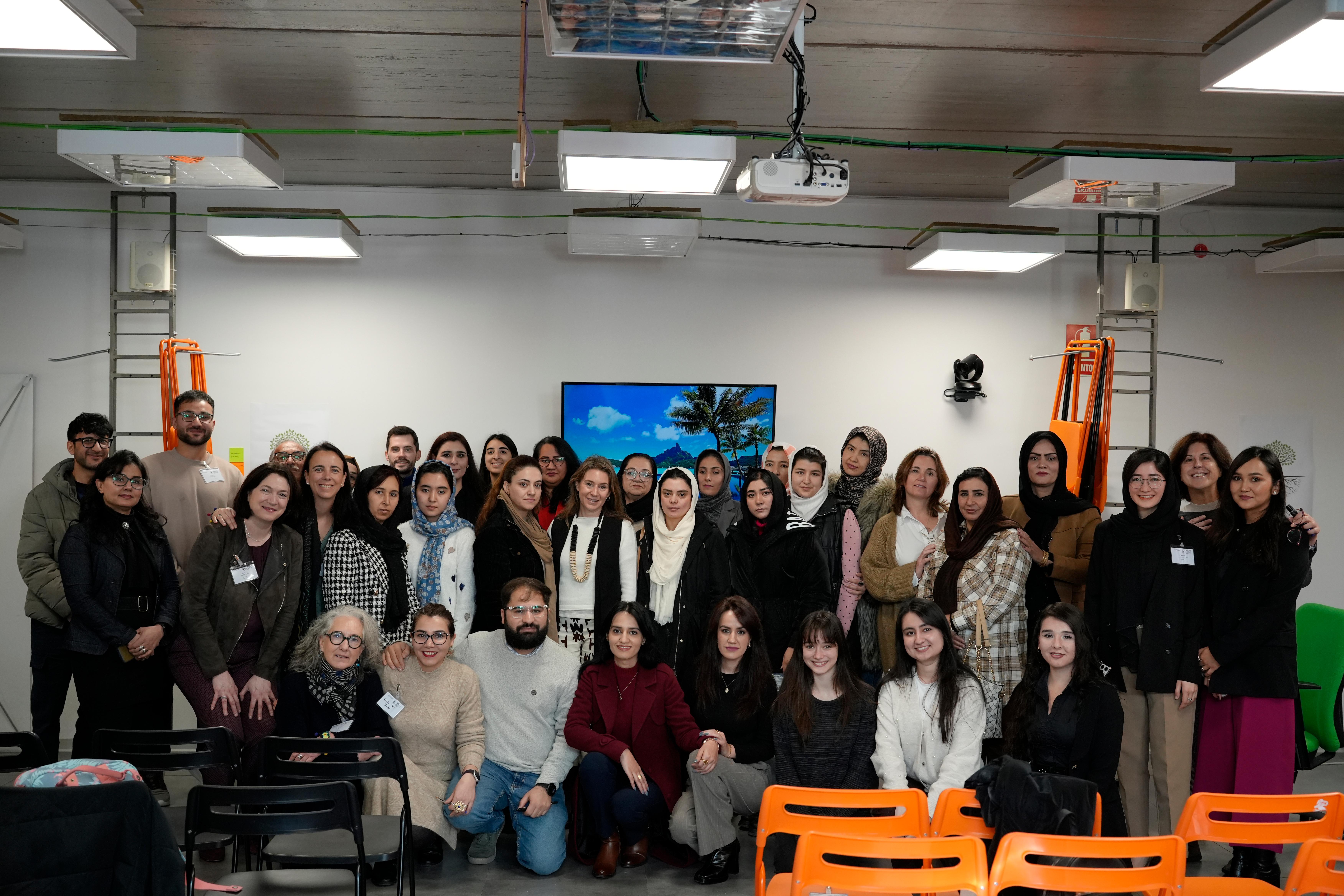 Un grupo diverso de personas posan juntas en un ambiente interior contemporáneo.