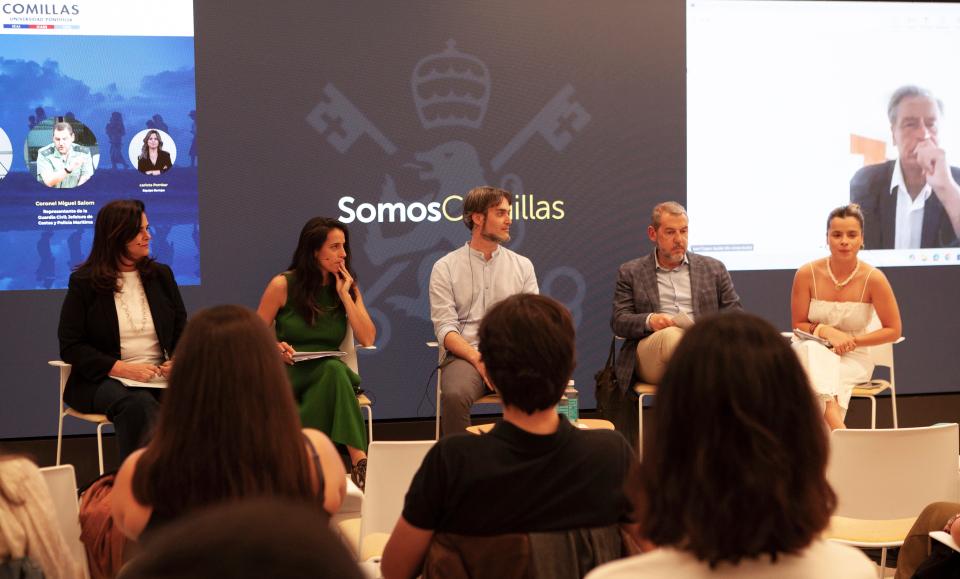 Una mesa redonda con varios panelistas discutiendo en un evento.