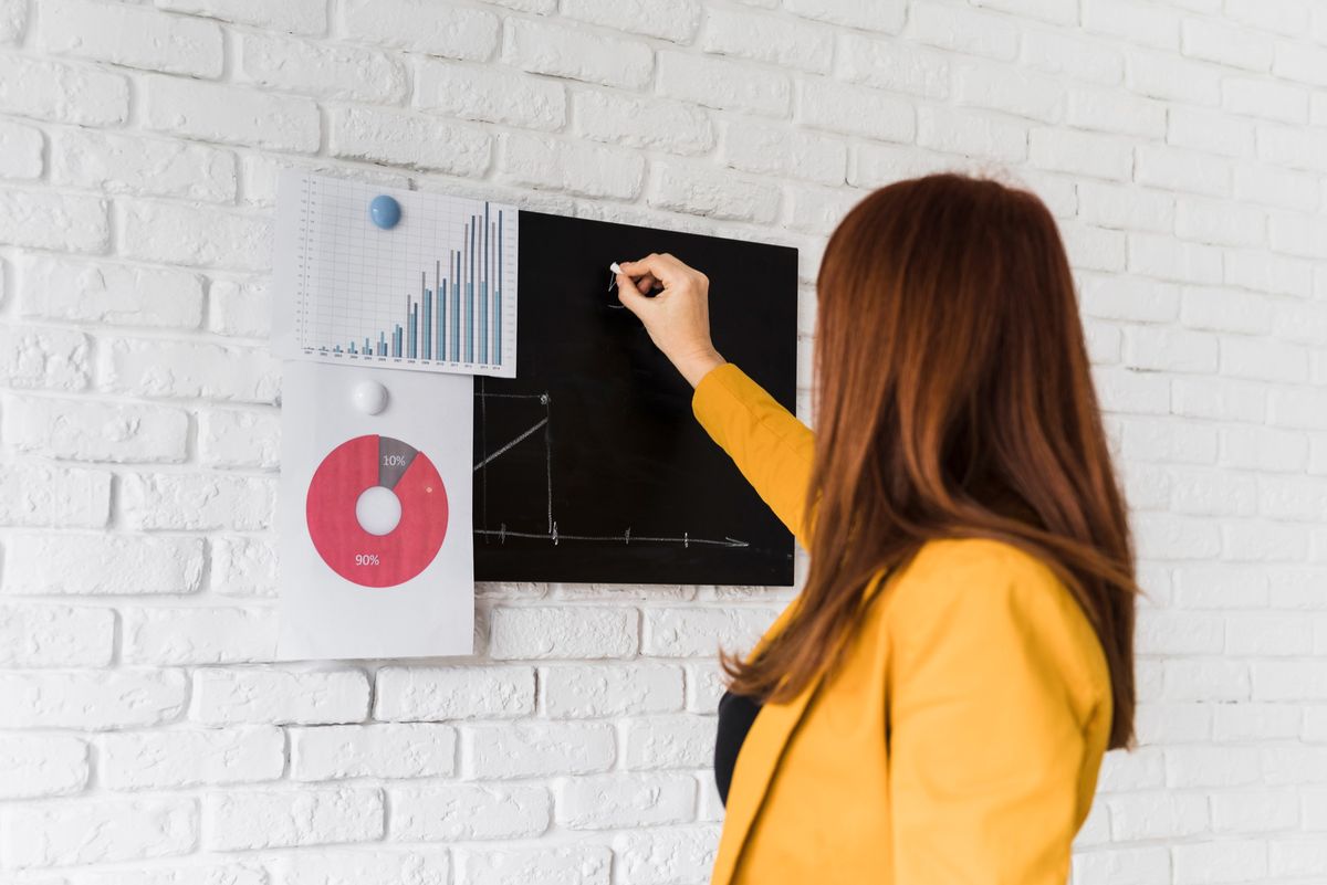 mujer analizando datos en pizarra