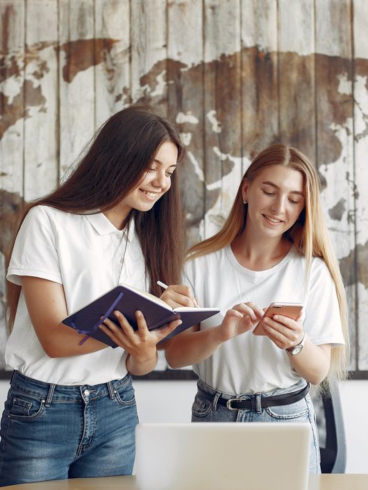 two-girls-white-t-shirts-working-office.jpeg